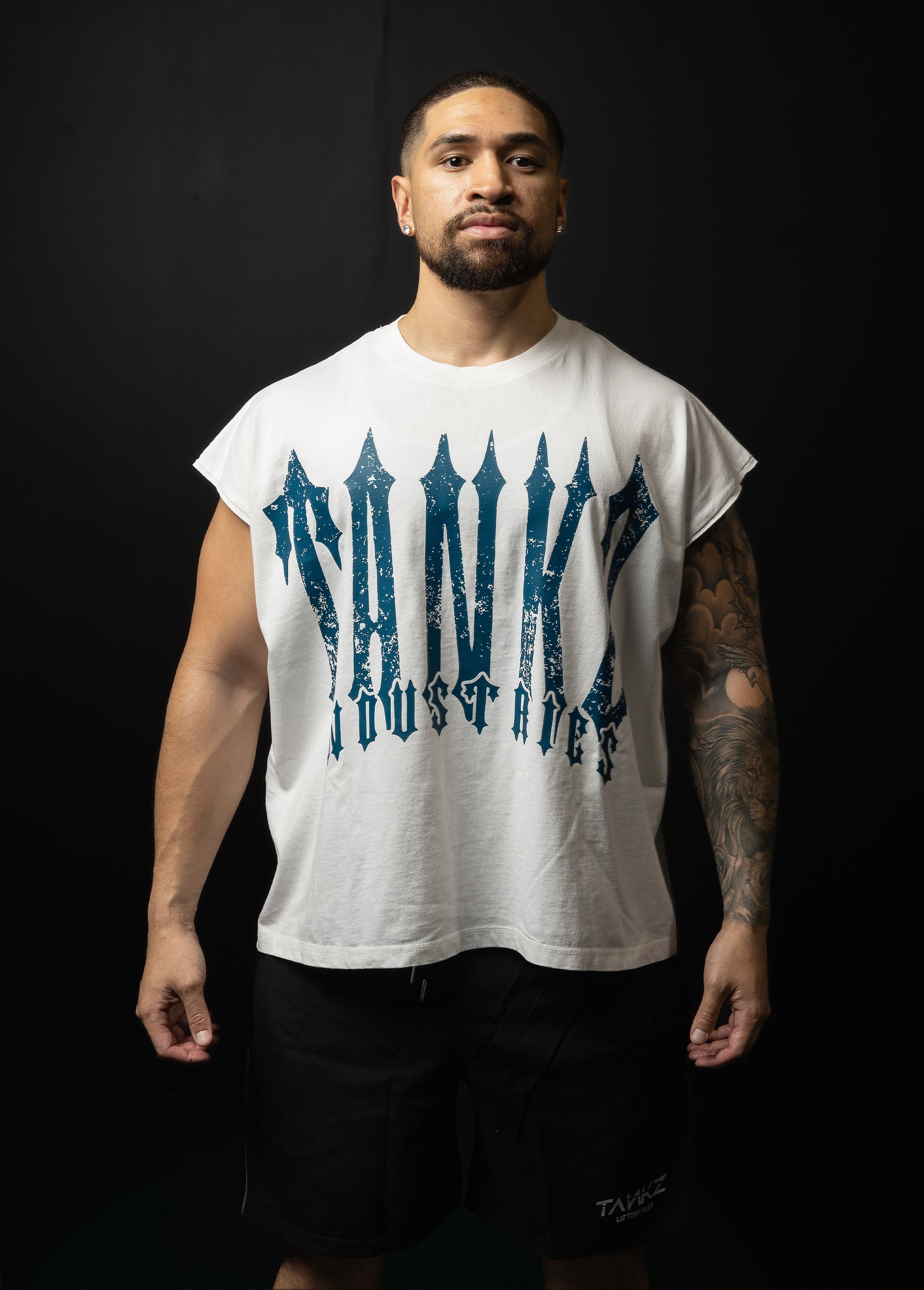 Man wearing a white t-shirt with blue text against a black background