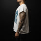Man wearing a white t-shirt with text and black shorts on a dark background